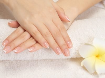 Woman gets manicure procedure in a spa salon. Beautiful female h